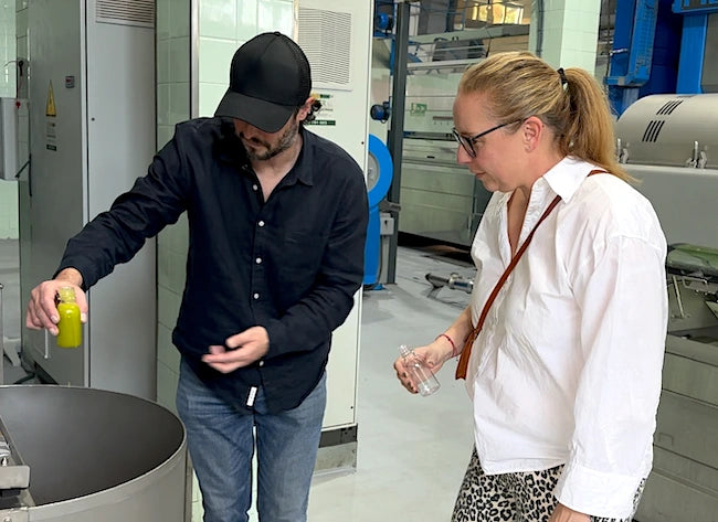 The couple behind Solivez at the olive mill, checking freshly pressed oil